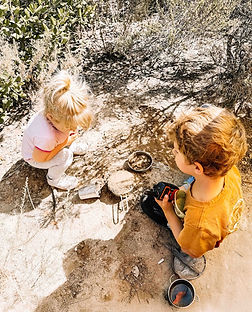 preschool aged learning mud kitchen